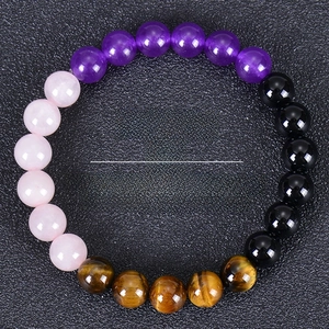 Detail of beaded fertility bracelet with multi-color stones and pregnancy support text
