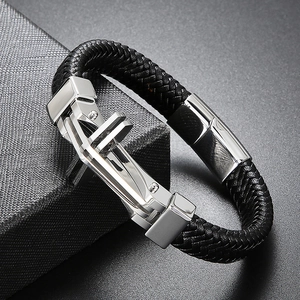 Detail of black woven leather texture and silver cross buckle on men's bracelet