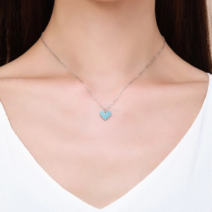 Elegant s925 silver heart necklace with turquoise blue stones on a model's neck