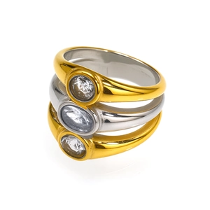 Detailed close-up of triple-layered gold and silver rings with oval cubic zirconia gems