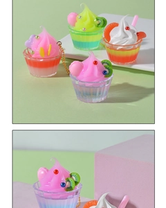 Close-up of colorful miniature cupcake charms with realistic cream and fruit details