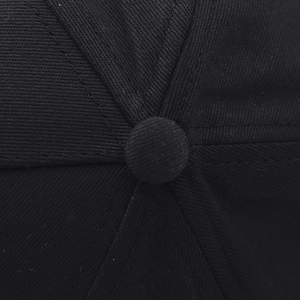 Macro detail of black cotton twill baseball cap with six-panel crown and top button