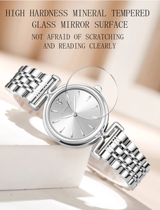 Detail view of silver stainless steel watch with diamond marker and mineral glass lens