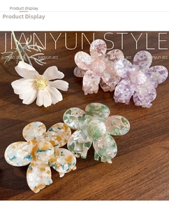Detailed close-up of acetate flower hair claws with marble patterns in macaron colors