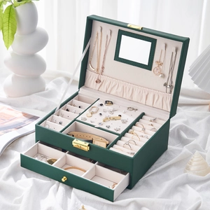 Detail view of double-layer dark green leather jewelry box with mirror and drawers