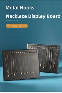 Detail view of rectangular necklace display board with metal hooks and premium texture
