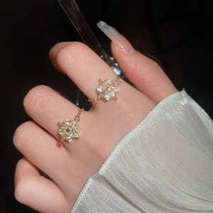 Exquisite Blumenringe mit rosa und weißen Zirkonia-Steinen getragen auf Goldbeschichtung