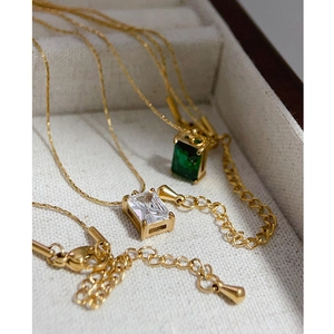 Gold plated emerald cut zircon pendant necklace set in a cream jewelry box