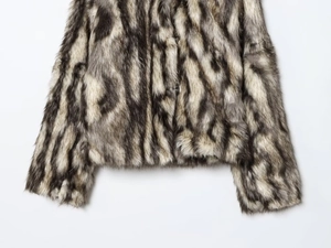 Detailed view of plush faux fur texture with black and grey animal print patterns