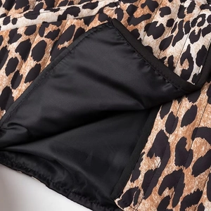 Close-up of high-quality black lining and leopard print fabric stitching on jacket