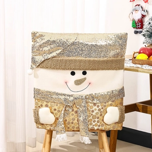 Detail of Christmas snowman chair cover with golden sequins and plush fabric on wood chair
