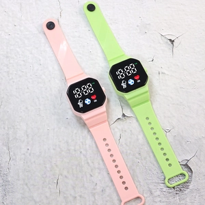 Detail of pink and green LED electronic watches with square digital screen and astronaut icons