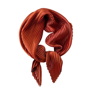 Reddish brown pleated satin silk scarf for women shown tied on a white background
