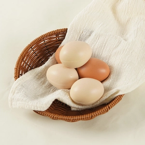 Realistic PU foam stress relief eggs in a woven basket with natural home setting