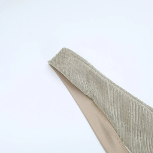 Close-up of champagne gold shimmering fabric with fine texture for a formal evening dress