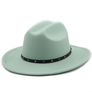 Macro detail of mint green wool fedora with black leather band and silver metal studs