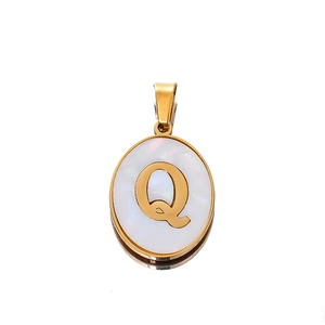 Detailed macro view of 22mm oval shell pendant with golden letter Q engraving