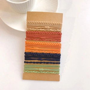 Detailed set of 15 colorful elastic hair ties displayed neatly on brown cardboard cards