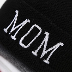 Black knitted beanie hat featuring white MOM letter embroidery on the cuffed brim