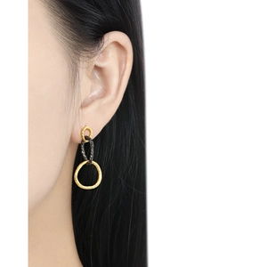 Three interlocking S925 silver textured geometric hoop earrings worn by a model