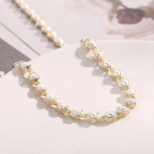 Elegant gold heart chain necklace with white pearls for women in minimalist style