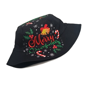 Close-up of the Merry Christmas print and festive icons on a black cotton bucket hat