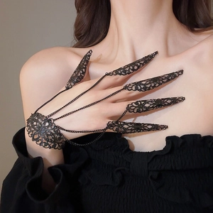 Detailed view of exotic black hollow flower armor ring with layered hand chain accessory