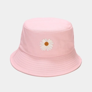 Close-up of a pink cotton bucket hat featuring a detailed white daisy flower embroidery