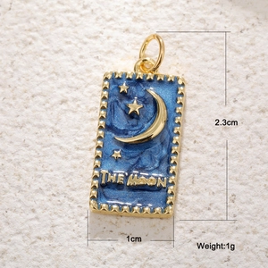 Macro detail of The Moon tarot card pendant with blue enamel and gold stars engraving