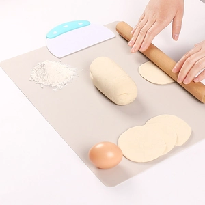 Close-up of food-grade silicone baking mat with rolling pin and dough scraper set