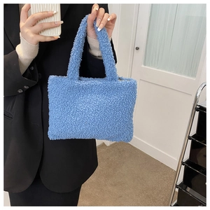 Close-up of fluffy blue plush handbag featuring soft texture and stylish square handle