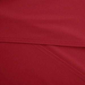 Detailed close-up of double-stitched seams on high-quality red satin evening dress fabric