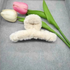 Close-up of 11cm large beige plush shark hair claw clip with faux fur texture for winter