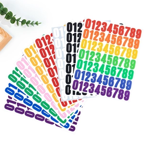 Close-up of colorful 1-inch vinyl number stickers with a rainbow color palette on white