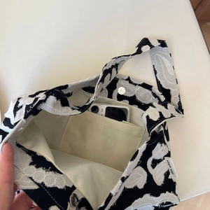 Detailed interior of minimalist cotton linen shoulder bag with inner pocket and magnetic snap