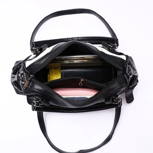 Contrast color black and white leather tote bag showing spacious interior compartments