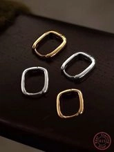 Detailed view of gold and silver rectangle hoop earrings made of S925 sterling silver