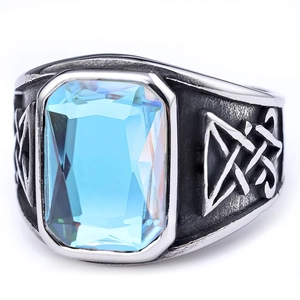 Detail of vintage silver ring featuring a light blue square gemstone and Celtic carving