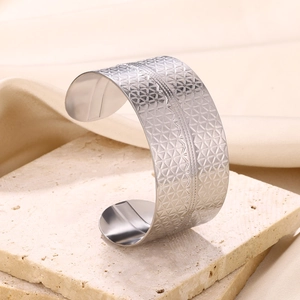 Detailed view of wide cuff bracelet featuring geometric triangle patterns and hammered texture