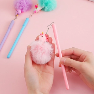 Close-up of pink unicorn cartoon pen featuring a soft pom-pom and cute charm