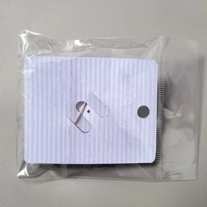 Back view of premium pearl brooch packaged on a purple striped card in clear OPP bag