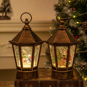 Vintage bronze Christmas lanterns with snowman and Santa scenes on book base