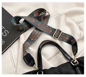 Close-up of black nylon tote bag featuring a colorful geometric patterned shoulder strap