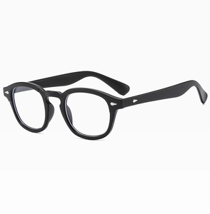 Close-up of black retro round frames with signature metal rivets and clear lenses