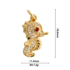 Macro shot of 18.6mm gold seahorse pendant with clear zircons and red gemstone eye