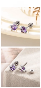 Detailed view of the purple zircon planet earring with silver orbital ring design