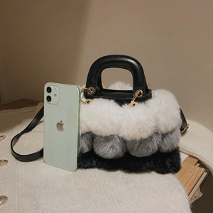 Mini plush patchwork handbag with white, gray, and black fur balls and leather strap