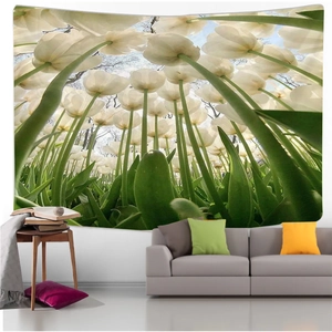 Detail of wall tapestry featuring white tulips and blue sky above a grey sofa
