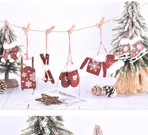 Close-up of wooden Christmas ornaments hanging on a rope with snowflakes and fur details