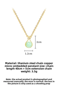 Detail of gold titanium lucky bag necklace with green bead and zircon bow pendant
